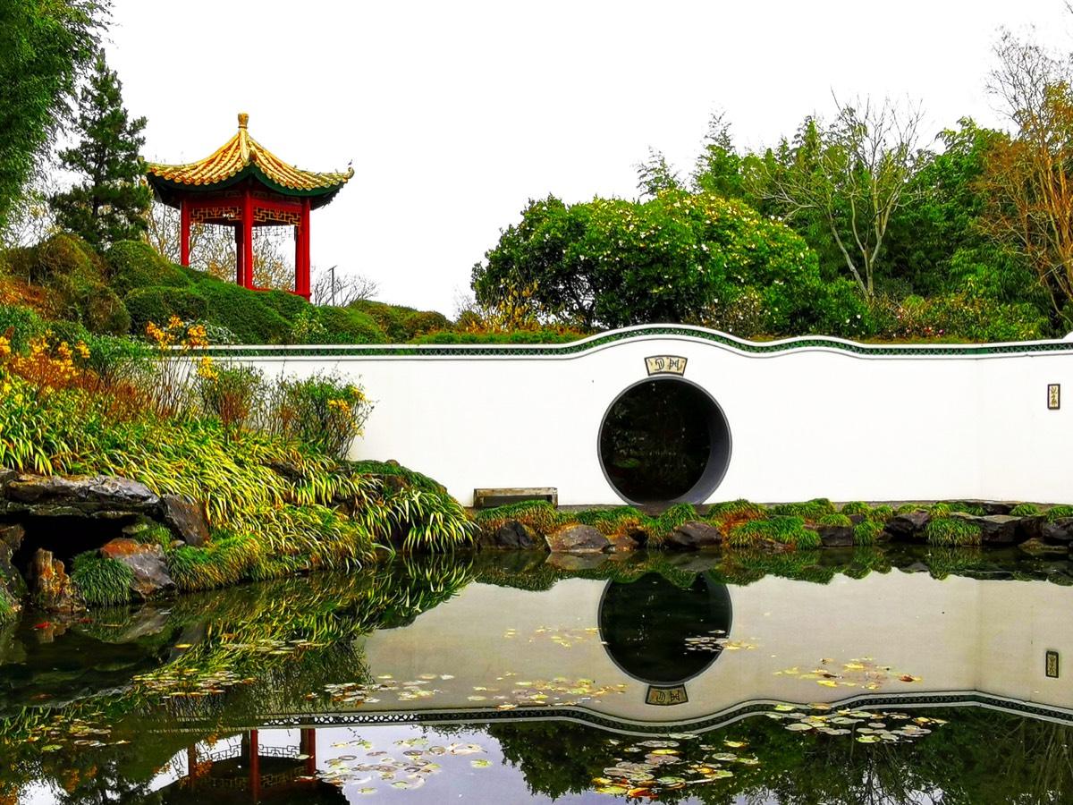 Moon gate, pavilion and pond in the Chinese Scholars Garden at Hamilton Gardens